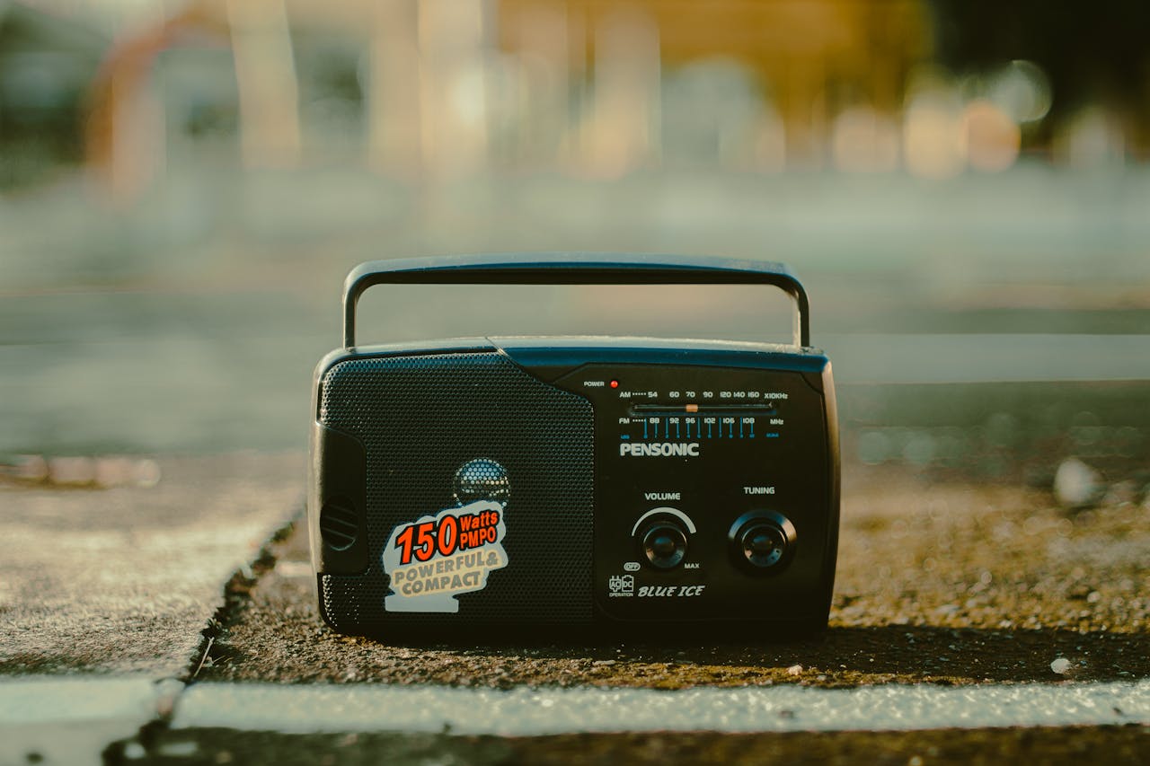 our-mission A retro portable radio on an urban surface, evoking a vintage and nostalgic vibe.