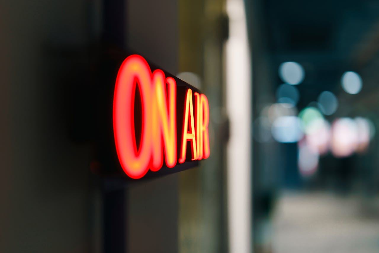 Close-up of an illuminated 'On Air' sign symbolizing live broadcasting in a studio.